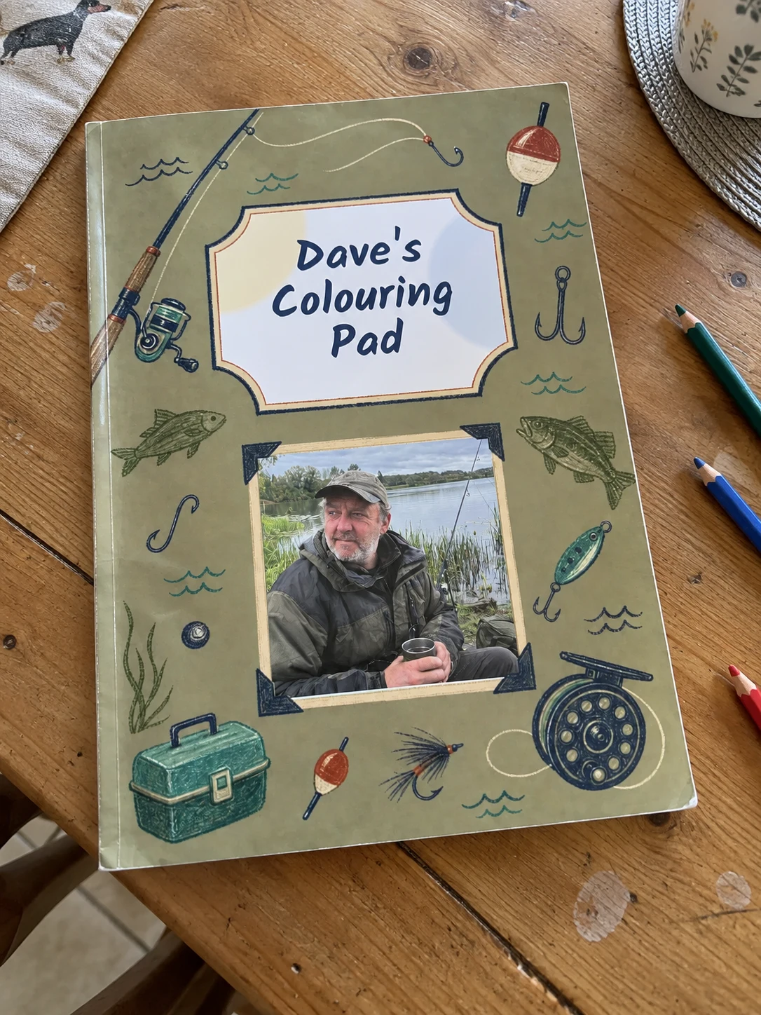 Fishing personalised colouring book example photographed on a table