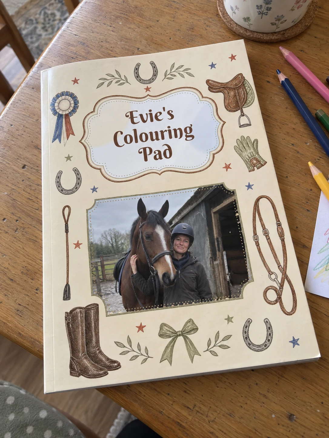 Horse riding personalised colouring book example photographed on a table